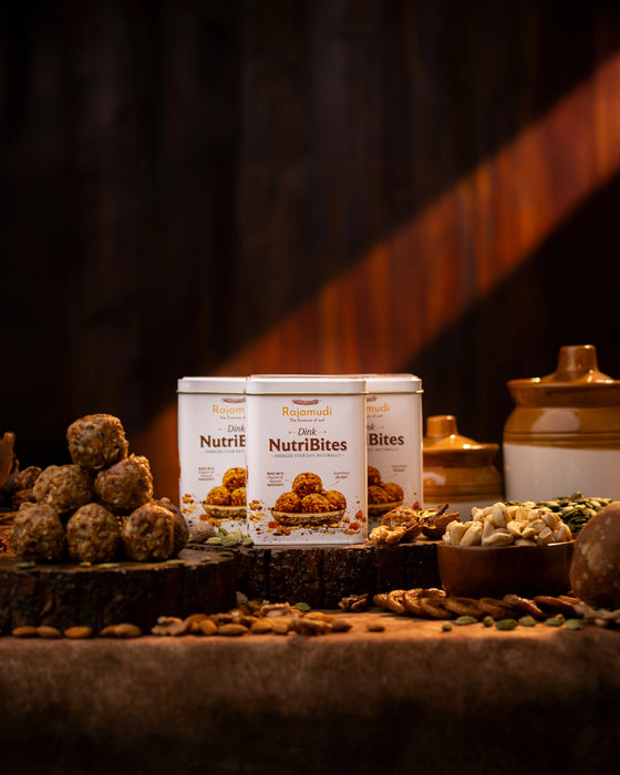 Three containers of NutriBites on a rustic wooden surface with a dark background